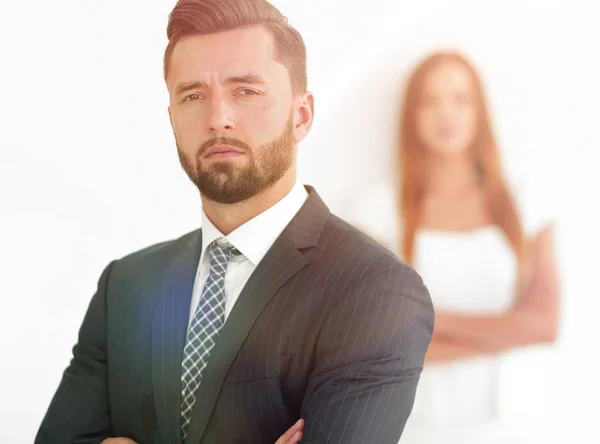 Portrait of a businessman with a woman in the background — Stock Photo, Image