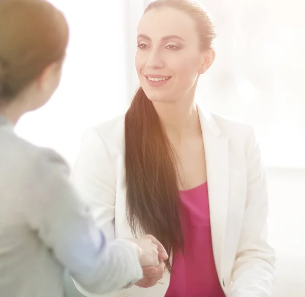 stock image handshake business woman with a client