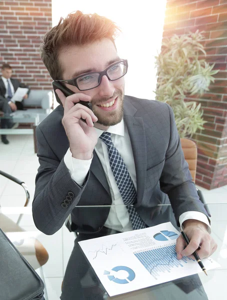 Hombre de negocios hablando en el teléfono inteligente en su escritorio — Foto de Stock