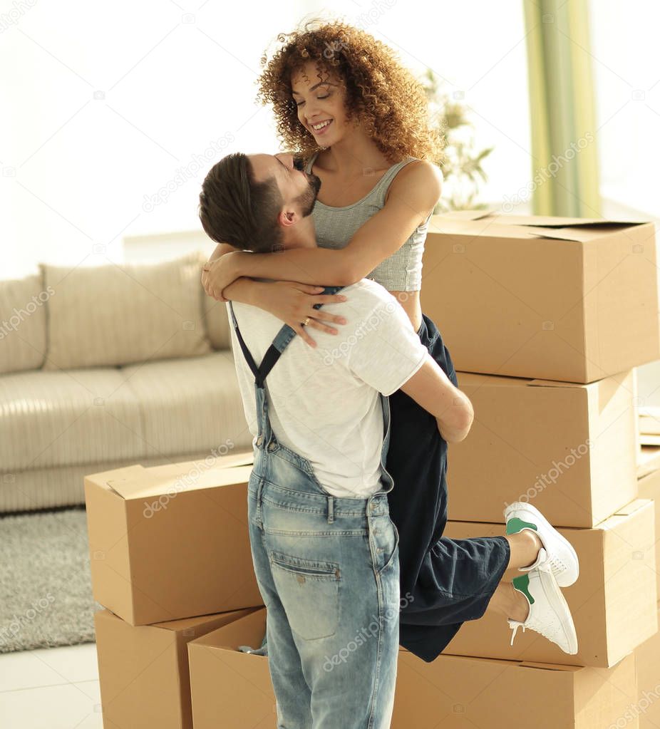 young couple hugging each other in new apartment.