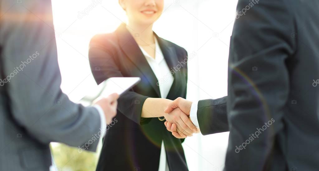 Businesswoman shaking hands with a businssman during a meeting