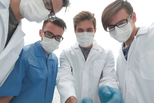 Κινηματογράφηση σε πρώτο πλάνο. μια ομάδα γιατρών σε προστατευτικές μάσκες. — Φωτογραφία Αρχείου