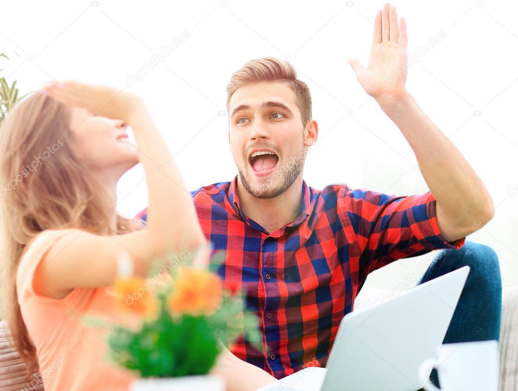 happy young couple giving each other a high five
