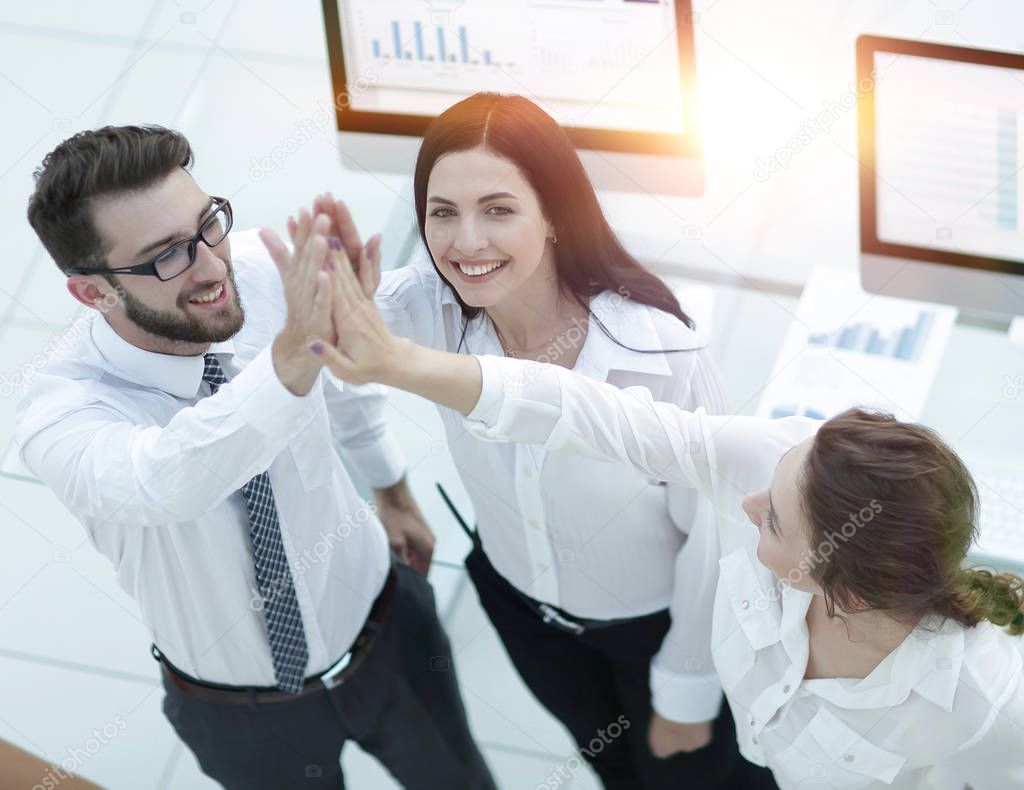 successful business team giving each other a high five .