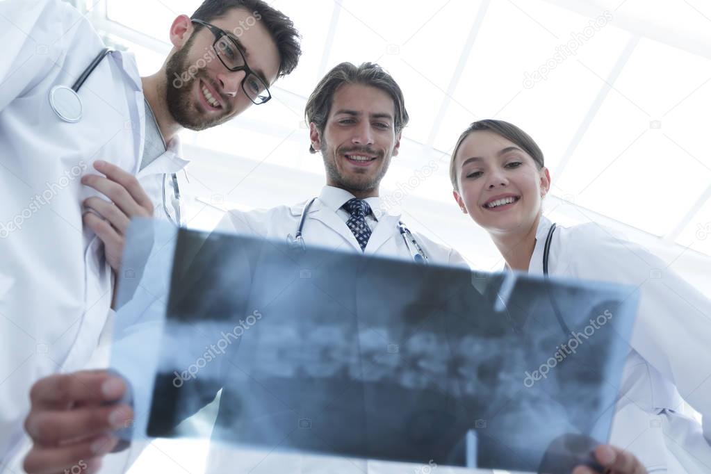bottom view young group of doctors looking at x-ray