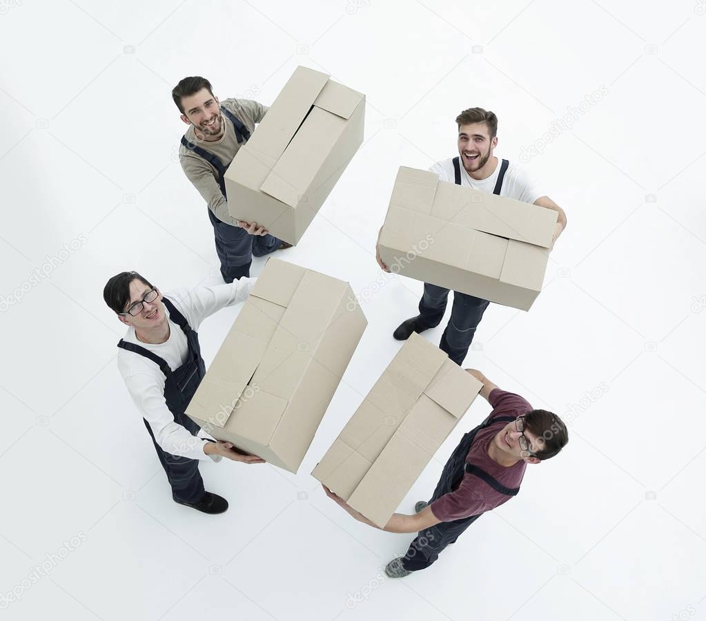 Movers lifting stack of cardboard moving boxes isolated on white