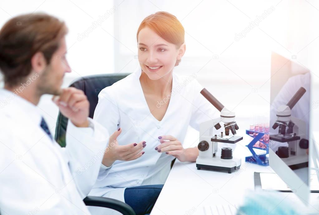 Side view of two scientists conducting a chemical experiment