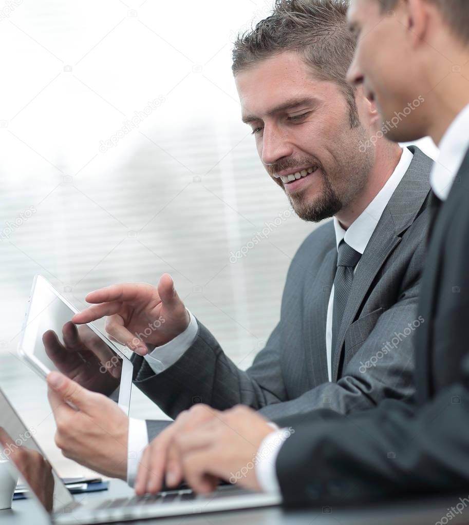 business colleagues working with tablet computer.