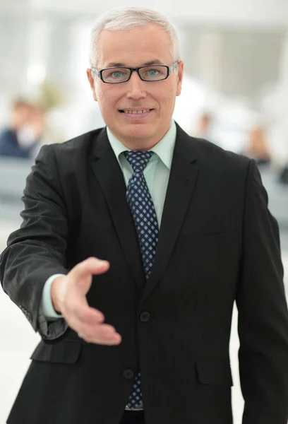 Closeup of a senior businessman offering his hand for greeting. — Stock Photo, Image