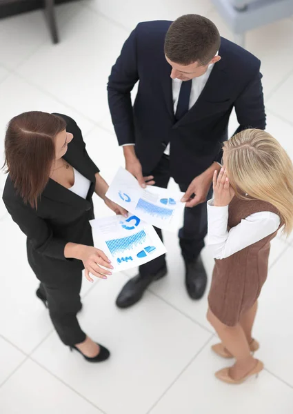 View from the top. business team discussing financial charts standing in the office — Stock Photo, Image