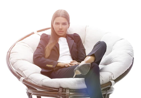 Young business woman relaxes in a round chair — Stock Photo, Image