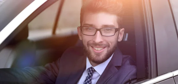 Businessman in suit driving his luxurious car. — Stock Photo, Image