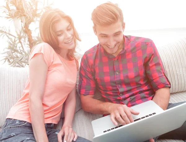 Happy modern couple surfing the net and working on laptop at home — Stock Photo, Image