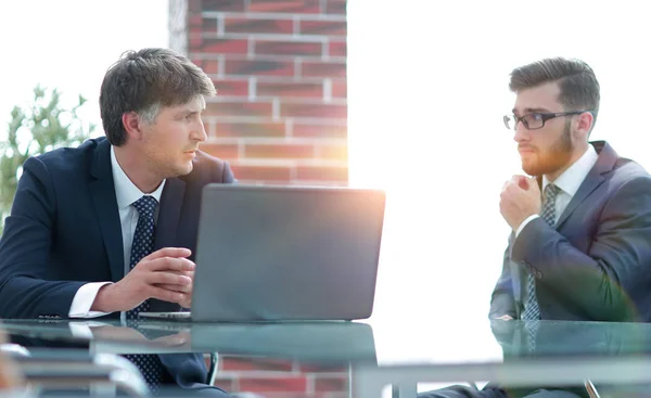 Deux hommes d'affaires travaillant sur un ordinateur portable dans le bureau — Photo