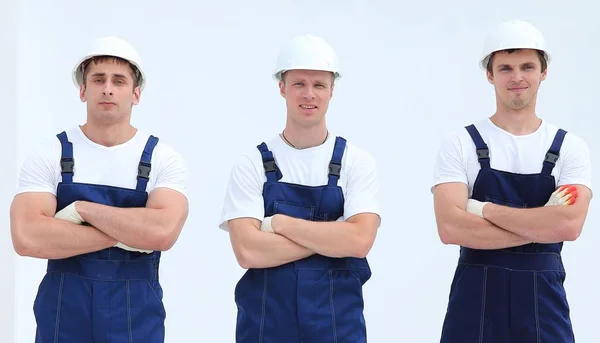 Successful team builders in overalls and helmets — Stock Photo, Image