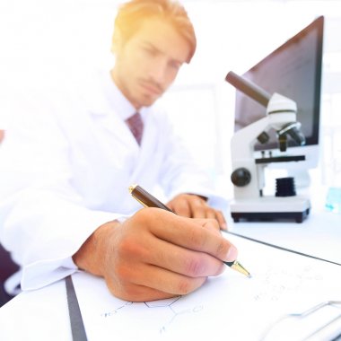 Bilimadamı laboratuarda bir deney notu yazar.