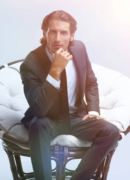 Confident businessman sitting in chair — Stock Photo, Image