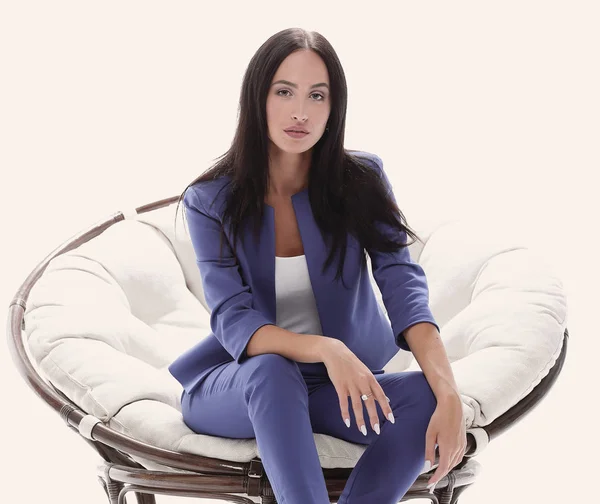 Portrait of a young woman in a blue suit sitting on a soft chair — Stock Photo, Image