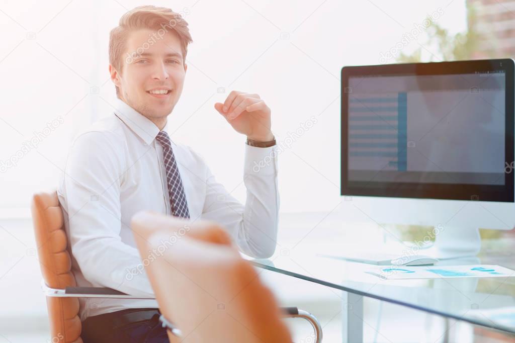 employee sitting in front of a computer screen