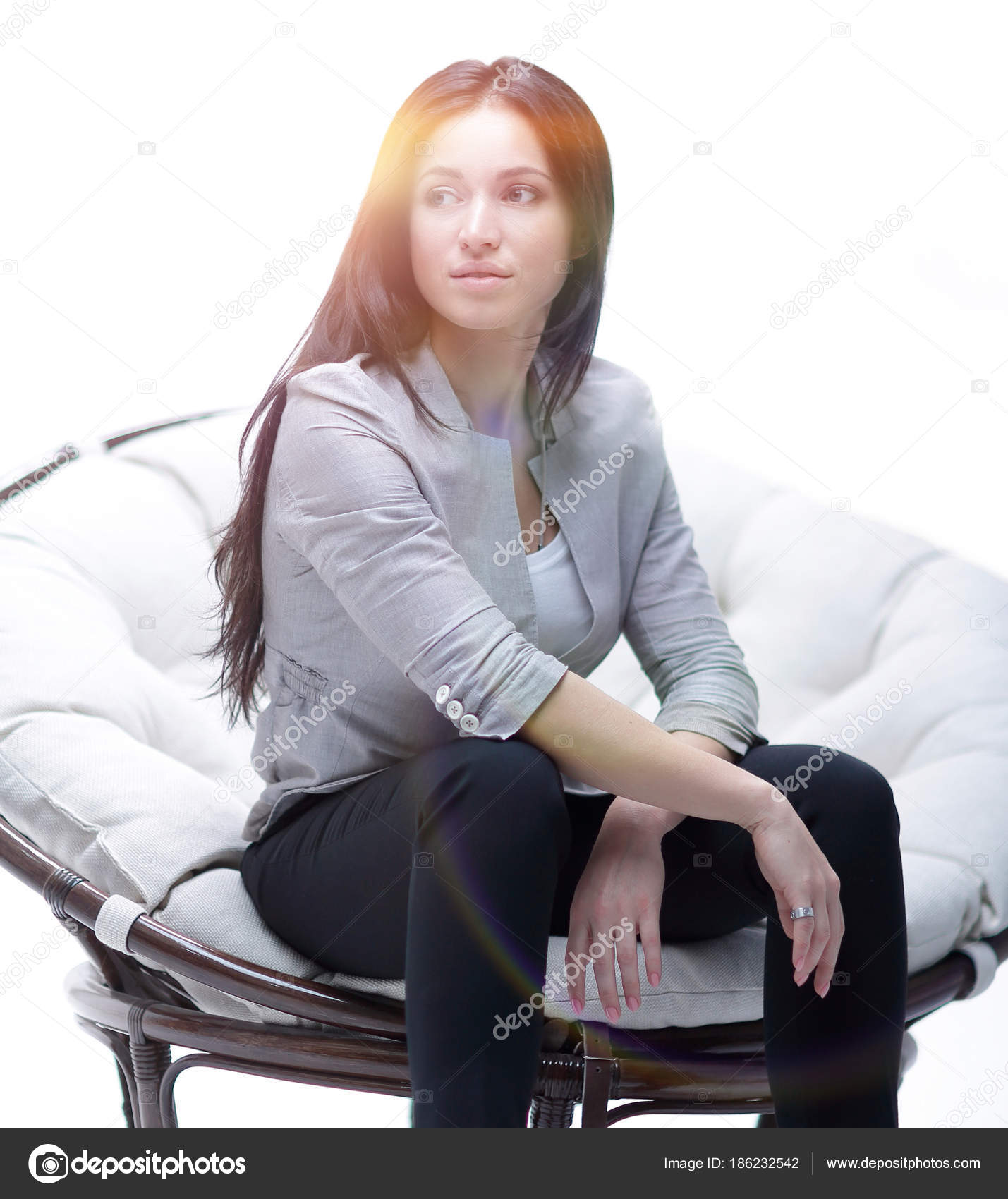 Young Woman Sitting In A Round Cozy Soft Big Chair Stock
