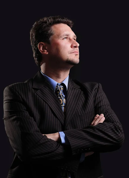 Successful businessman on a dark background. — Stock Photo, Image