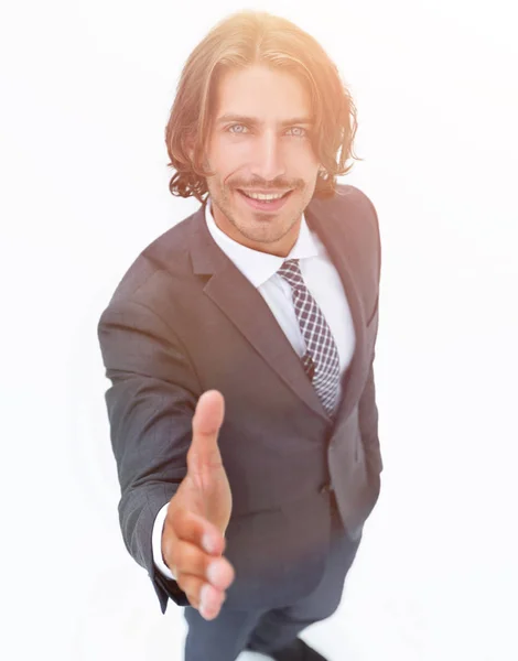 Business man extending hand to shake - focus om hand Stock Picture