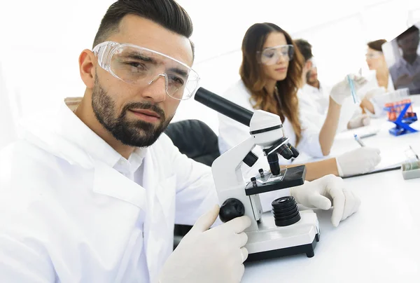 Closeup of male technician sitting at his working in the laboratory — Stock Photo, Image