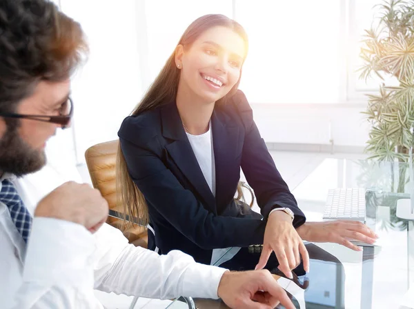 businessman and his female assistant sitting at a Desk