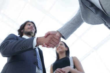 İş adamları geniş pencereli odaya karşı el sıkışıyor