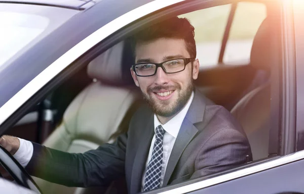 Businessman in suit driving his luxurious car. — Stock Photo, Image