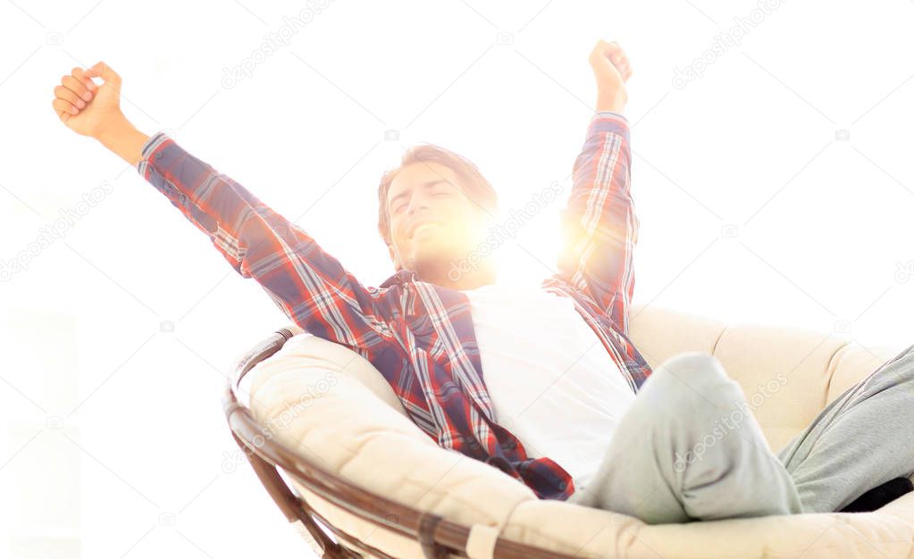 stylish guy stretching in a comfortable chair