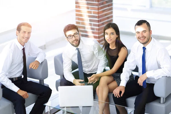 Equipe de negócios bem sucedida sentado no lobby do escritório — Fotografia de Stock