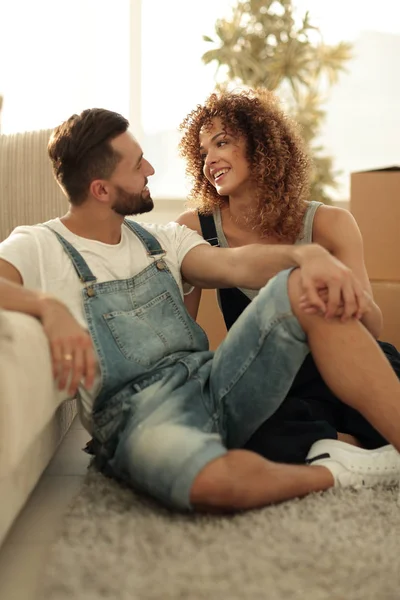 Pareja joven sentada en el sofá y soñando con el futuro —  Fotos de Stock