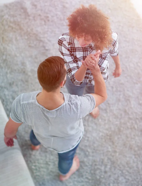 Young couple give each other five in new living room — Stock Photo, Image