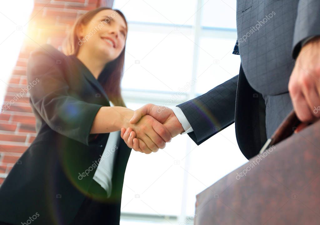 Close up of businessman and businesswoman shaking hands