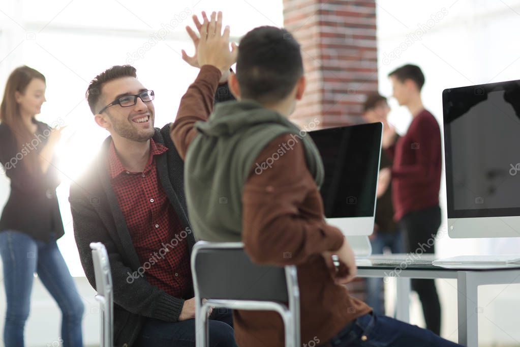 business colleagues giving each other high five