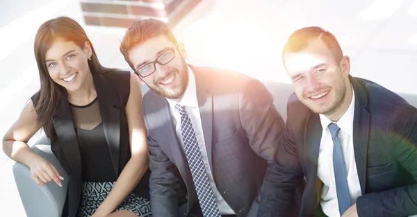Portrait of successful business team sitting in office lobby — Stock Photo, Image
