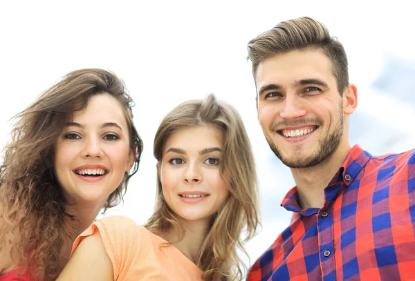 Close-up de três jovens sorrindo em fundo branco — Fotografia de Stock