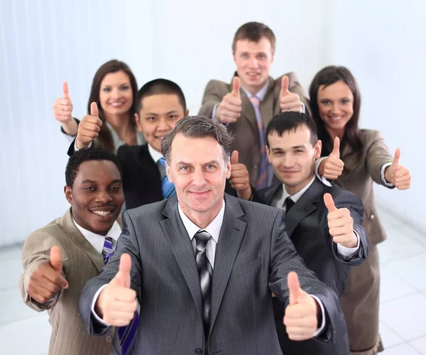 Happy business team holding thumbs up — Stock Photo, Image