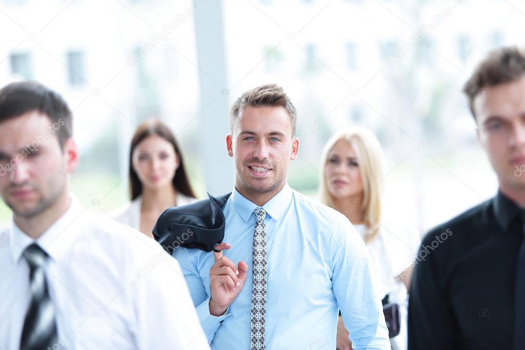 confident businessman on background of a blurred office.