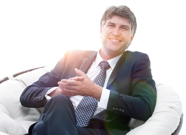 Successful businessman sits in a soft comfortable chair. — Stock Photo, Image