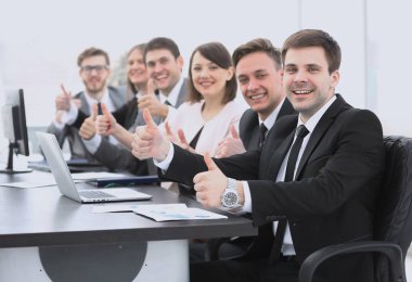success in business.close-knit business team holding thumbs up clipart