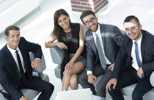Portrait of successful business team sitting in office lobby — Stock Photo, Image
