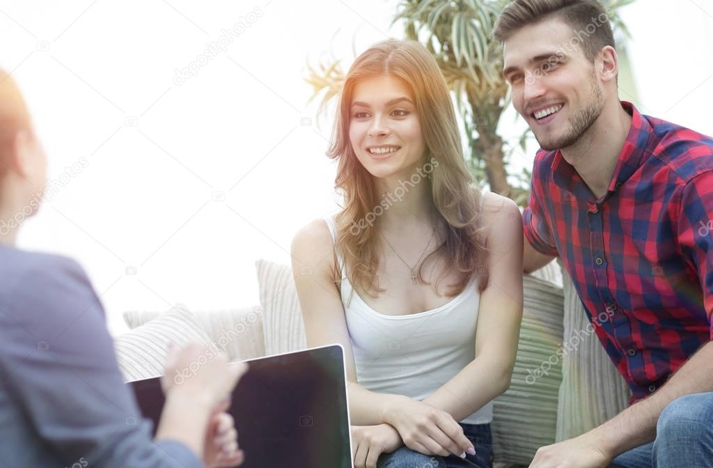 Young happy couple at therapy session with family psychologist