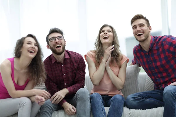 Group of cheerful young people sitting on the couch. — Stock Photo, Image