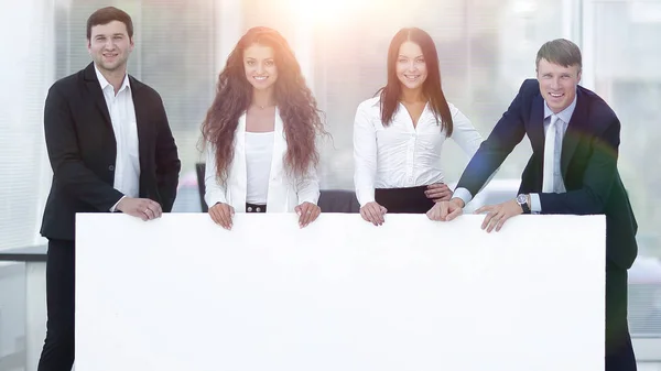 Business team holding blank white banner — Stock Photo, Image