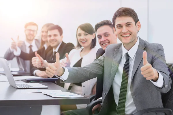 successful business team showing thumbs up