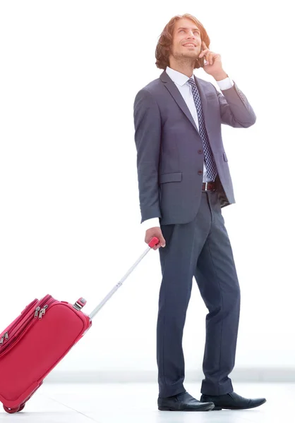 Businessman with Luggage talking on a cell phone. — Stock Photo, Image