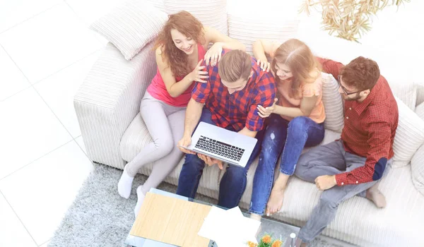 Fröhliche Gruppe von Freunden schaut sich die Videoclips auf dem Laptop an — Stockfoto