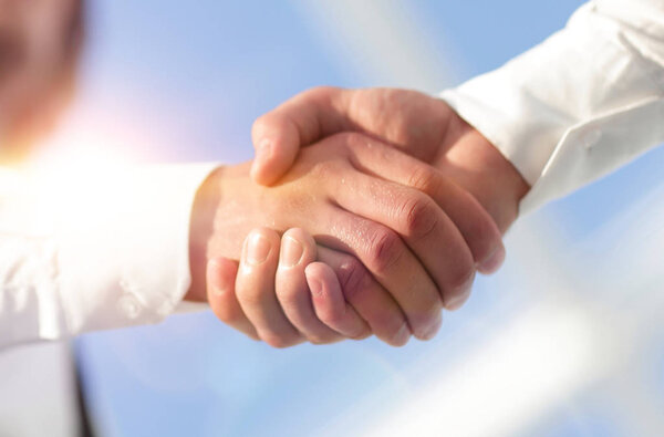 Close-up photo of handshake of two successful businessmen